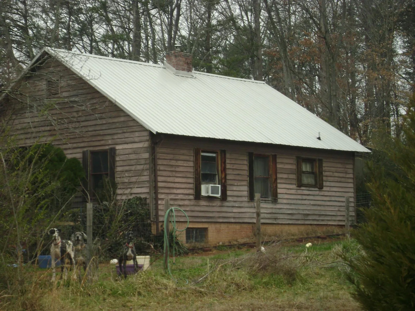 White metal roof on an old wood sided farmhouse, from a Metal Roof Installation job in Leetsdale